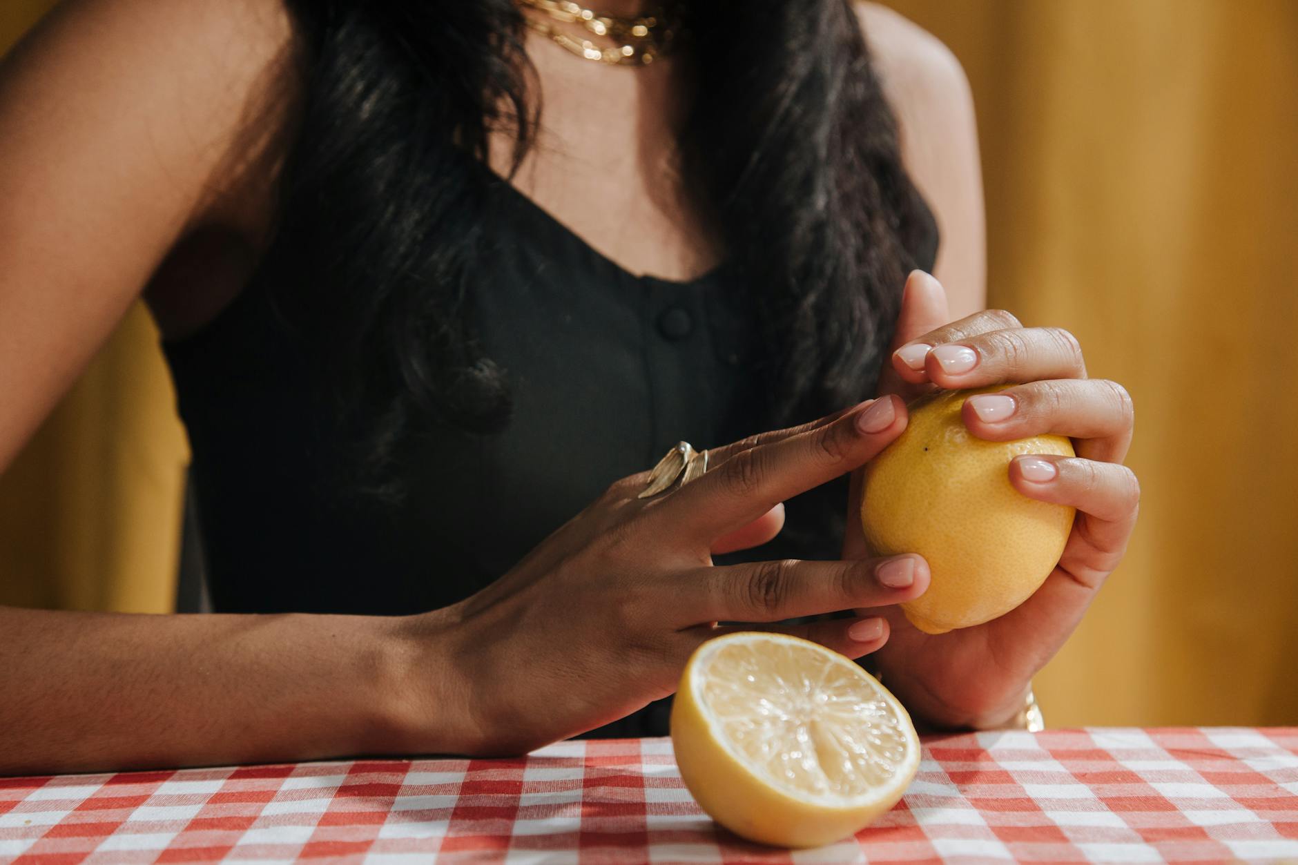 Woman holding a fresh lemon, representing natural pleasure solutions