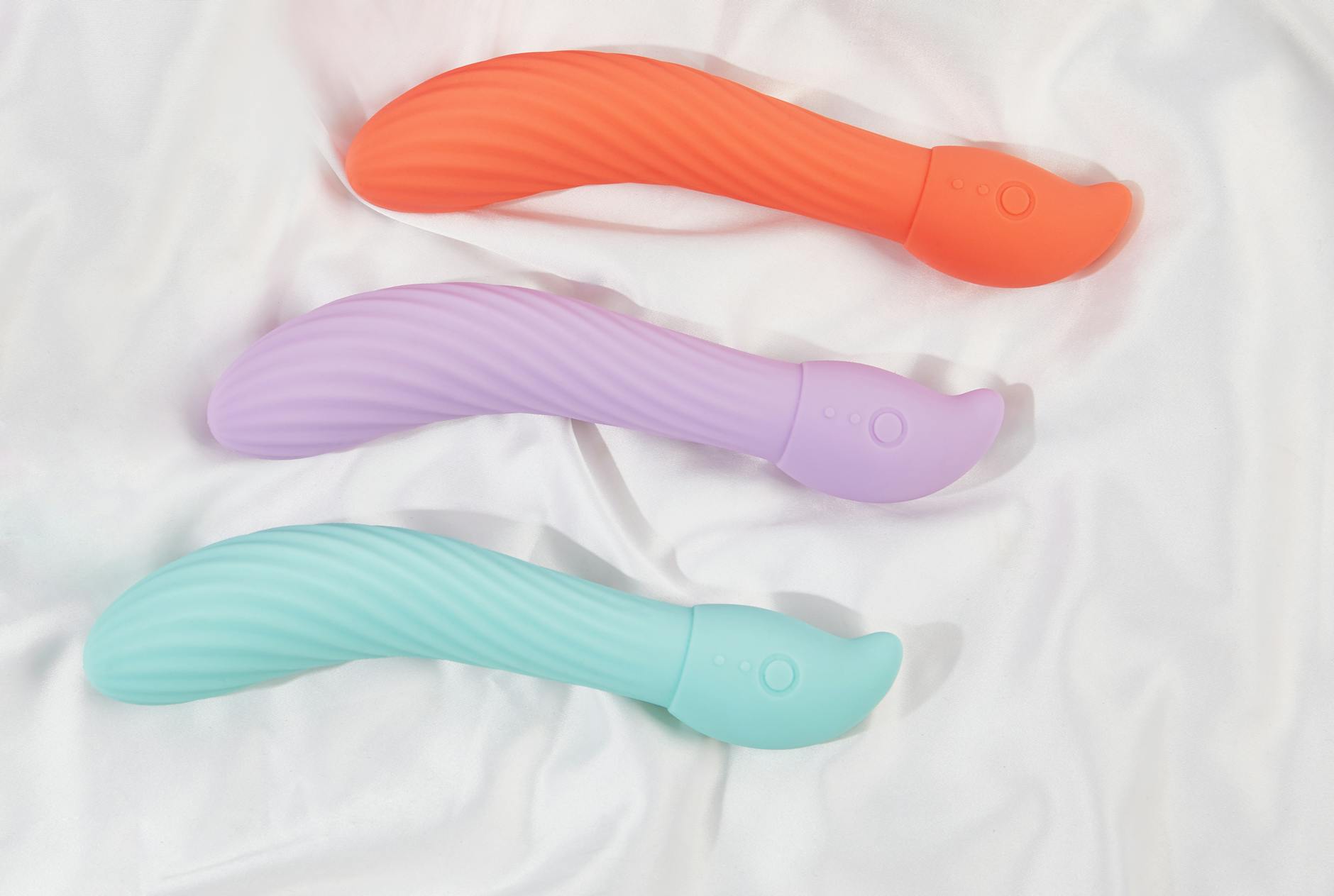 Colorful vibrators arranged on white fabric