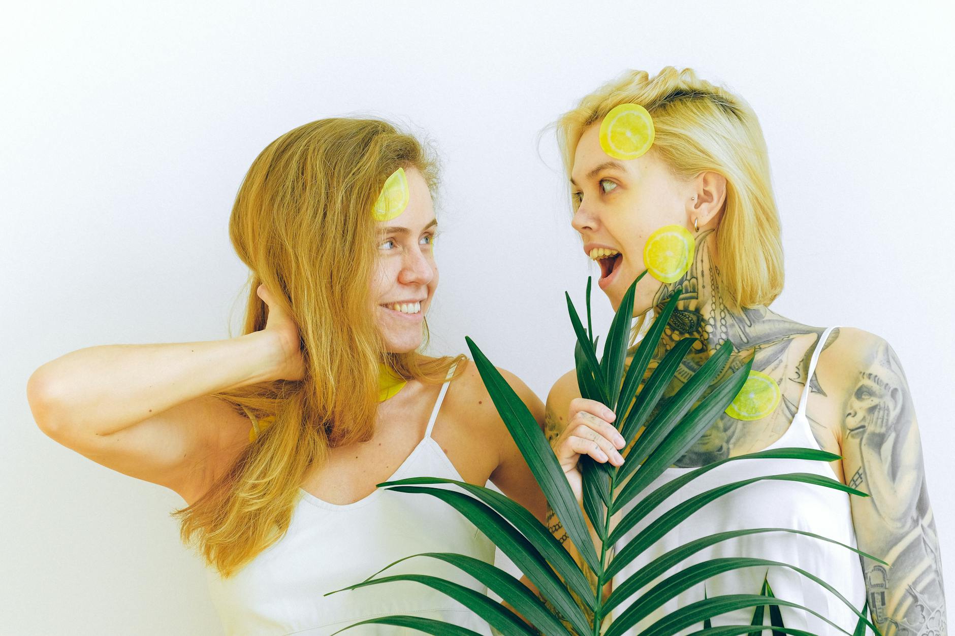 Two women laughing together, expressing joy and connection indoors