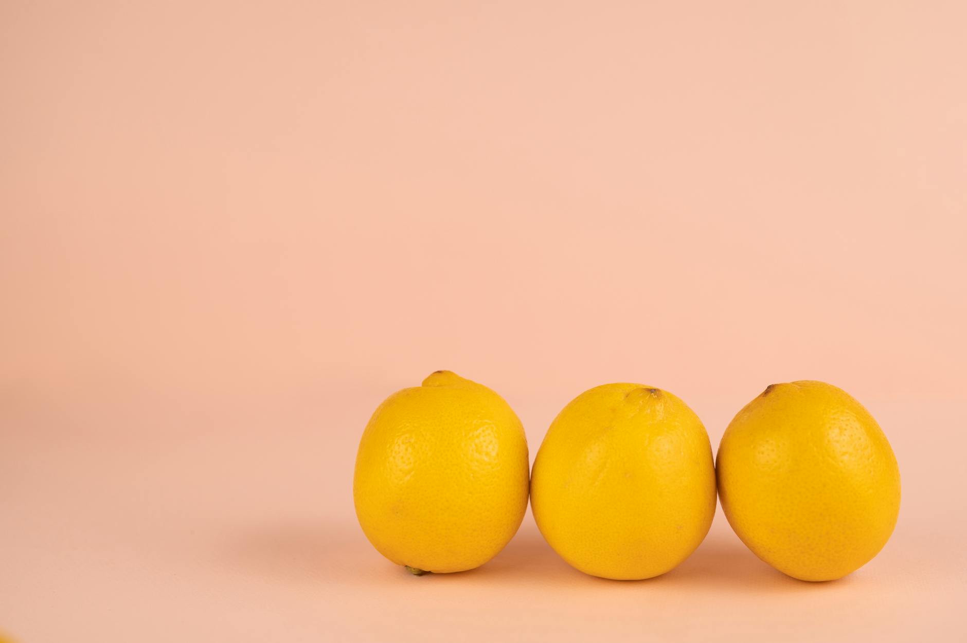 Bright ripe lemons arranged on a pastel background, representing the science of lemon vibrators